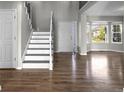 Welcoming foyer featuring a staircase, hardwood floors, and a view to the front entrance at 8414 Bed Straw St, Parker, CO 80134