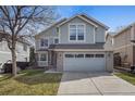 Charming two-story home with a well-maintained lawn, mature tree, and a two-car garage at 8414 Bed Straw St, Parker, CO 80134