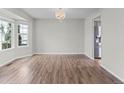 Bright and spacious living room with wood floors, large windows and elegant lighting at 8414 Bed Straw St, Parker, CO 80134