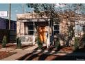 Charming brick home with an inviting front porch and a bright orange front door at 3746 Jason St, Denver, CO 80211