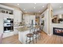 Bright kitchen with white cabinets, granite countertops, stainless steel appliances, and an island with seating at 3228 Country Club Pkwy, Castle Rock, CO 80108