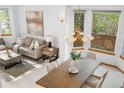Elegant dining area with a modern chandelier and sunlit windows at 10047 Sylvestor Rd, Highlands Ranch, CO 80129