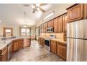 Spacious kitchen with sleek stainless steel appliances, ample wood cabinetry, and lots of counter space at 1526 Peach Ct, Brighton, CO 80601