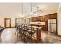 Modern kitchen features a large island with bar seating, stainless steel appliances, and granite countertops at 1526 Peach Ct, Brighton, CO 80601