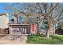 Charming two-story home with a two-car garage and a well-manicured front yard at 5027 E Barrington Ave, Castle Rock, CO 80104
