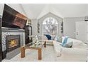Bright living room featuring a fireplace, vaulted ceilings, and comfortable seating at 5027 E Barrington Ave, Castle Rock, CO 80104