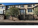 Attractive townhome featuring a two-car garage and stone accents at 11328 W Radcliffe Dr, Littleton, CO 80127