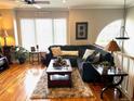Cozy living room featuring a comfortable sectional couch and natural light from a bright window at 11328 W Radcliffe Dr, Littleton, CO 80127