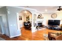 Spacious living room with a fireplace, hardwood floors and office space at 11328 W Radcliffe Dr, Littleton, CO 80127