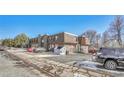 The rear view of the condo complex, with ample parking and landscaping at 8330 Zuni St # 219, Denver, CO 80221