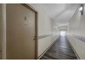 Long, well-lit hallway with durable flooring, leading to a bright exit at 8330 Zuni St # 219, Denver, CO 80221