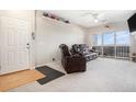 Comfortable living room with plush seating, carpet, and a door leading to the balcony at 9318 Las Ramblas Ct # R, Parker, CO 80134