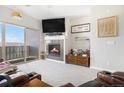 Cozy living room features a modern fireplace and sliding glass doors to the outdoor balcony at 9318 Las Ramblas Ct # R, Parker, CO 80134