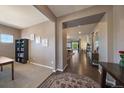 Spacious foyer showcasing hardwood floors and a view into the open-concept living spaces, blending carpeted and wood surfaces at 5437 S Granby Ct, Aurora, CO 80015