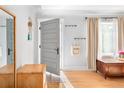 Bright entryway featuring wood floors, coat racks, and classic architectural details at 4590 Grove St, Denver, CO 80211