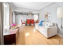 Open living and dining area with hardwood floors, natural light, and stylish furniture at 4590 Grove St, Denver, CO 80211