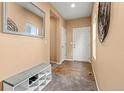 Inviting entryway features attractive tile, a useful shoe bench, a coat closet, and neutral paint at 9626 E 105Th Pl, Commerce City, CO 80640