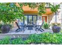 Stone patio with seating area and fire pit, surrounded by lush landscaping at 1237 S Saint Paul St, Denver, CO 80210