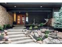 Inviting front entrance with double doors, stone steps, and lush landscaping at 12212 W 16Th Dr, Lakewood, CO 80215