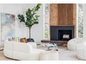 Cozy living room featuring a fireplace, large windows and hardwood floors at 12212 W 16Th Dr, Lakewood, CO 80215