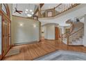 Grand foyer boasts hardwood floors, a staircase, and an open layout with a view to the second floor at 2880 Lake Meadow Dr, Monument, CO 80132