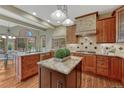 Gourmet kitchen featuring granite counters, custom cabinetry, and center island at 2880 Lake Meadow Dr, Monument, CO 80132