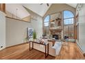 Bright living room features large windows, a stone fireplace, and elegant decor at 2880 Lake Meadow Dr, Monument, CO 80132