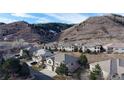 View of hillside homes with lush natural backdrop and beautiful architectural designs at 6931 Buckskin Dr, Littleton, CO 80125