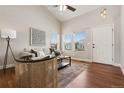 Light-filled living room with cathedral ceilings and access to the front porch through the front door at 9579 Bighorn Way, Littleton, CO 80125