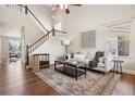Bright living room with high ceilings, hardwood floors, a staircase, and contemporary decor at 9579 Bighorn Way, Littleton, CO 80125