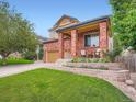 Beautiful two story home with front porch and manicured landscaping at 21220 E Nassau Ave, Aurora, CO 80013
