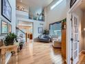 Sunlit living room with vaulted ceilings and beautiful wood floors at 21220 E Nassau Ave, Aurora, CO 80013