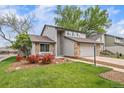 A quaint two-story house boasting a tidy front lawn, brick details, and a convenient two-car garage at 6398 S Emporia Cir, Englewood, CO 80111