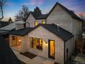 Back exterior showcasing a covered patio and outdoor fireplace at 2255 N Holly St, Denver, CO 80207