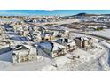 Aerial view of a residential neighborhood in a snowy landscape at 239 Rogers Ct, Castle Rock, CO 80104