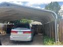 Carport and fenced yard featuring a vehicle, providing covered parking at 5040 Tennyson St, Denver, CO 80212