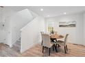 Bright dining area featuring a round wood table and seating for four, complemented by wood floors at 5242 Columbine Ln, Denver, CO 80221