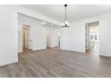 Spacious dining area with hardwood floors, leading to kitchen at 8773 Yellowcress St, Littleton, CO 80125