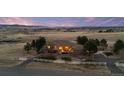 Idyllic property on sprawling acreage, secured by a white perimeter fence and a private circular drive at 5540 Horseshoe Trl, Sedalia, CO 80135