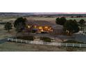 Lovely acreage with circular driveway and a white perimeter fence ensuring privacy and charm at 5540 Horseshoe Trl, Sedalia, CO 80135