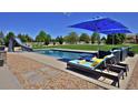 Backyard pool featuring a slide, lounge seating, a lawn and a safety fence at 1315 W 141St Cir, Westminster, CO 80023
