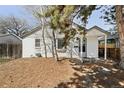 Charming home featuring a white brick exterior and mature trees in the front yard at 309 S Hudson St, Denver, CO 80246