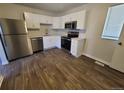 Bright kitchen featuring white cabinets, stainless steel appliances, and modern countertops at 5552 Abilene St, Denver, CO 80239