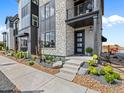 Inviting front entrance with stone accents and professional landscaping details at 1787 W 166Th Ave, Broomfield, CO 80023