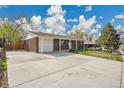 Charming single-story brick home featuring a large driveway and attached one car garage at 8353 Adams Way, Denver, CO 80221