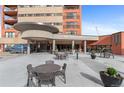 Building entrance with seating area and landscaping at 100 Park W Ave # 1804, Denver, CO 80205