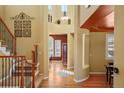 Inviting foyer with hardwood floors, grand staircase, and decorative wall accents at 11023 Glengate Cir, Highlands Ranch, CO 80130