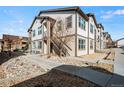 Exterior view of a two-story townhome featuring modern architectural design and manicured landscaping at 4604 Copeland Cir # 101, Highlands Ranch, CO 80126