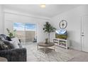 Bright and airy living room with balcony access, modern decor, and plenty of natural light at 15700 E Jamison Dr # 8-208, Englewood, CO 80112