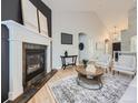 Bright living room with hardwood floors, fireplace, and vaulted ceilings for a spacious and inviting feel at 1020 S Ammons Cir, Lakewood, CO 80226